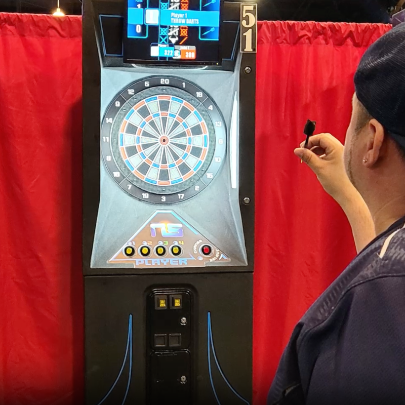 Dart Player preparing to throw dart at board. Network Sports/Medalist Dart League Logo in corner